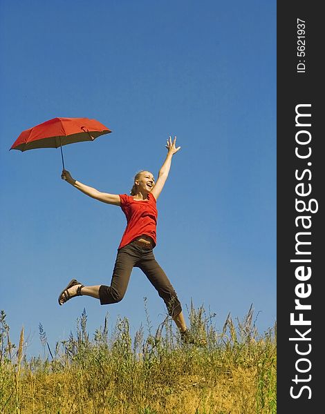 Girl jumping with red umbrella