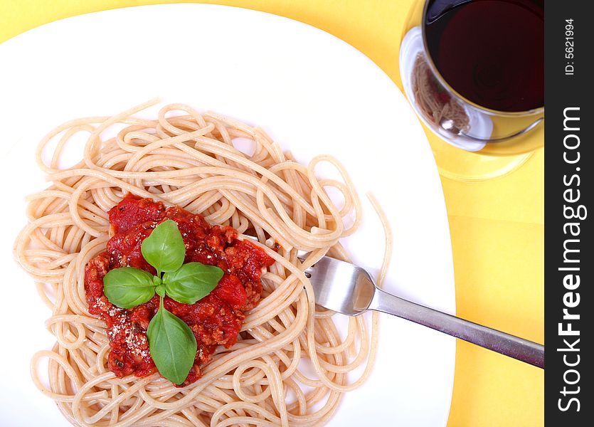 Spaghetti bolognes served on white plate and wine. Spaghetti bolognes served on white plate and wine