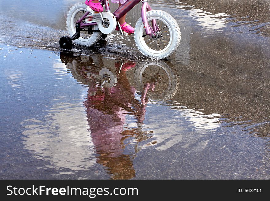 Reflection of a little girl on bycicle. Reflection of a little girl on bycicle