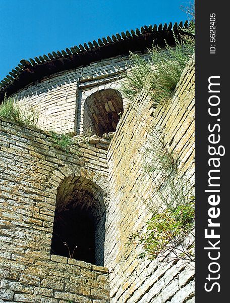 Embrasures of old brick fortress from below. Embrasures of old brick fortress from below