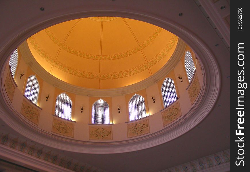 A beautiful designer orange dome from its inside with small windows on its side. A beautiful designer orange dome from its inside with small windows on its side