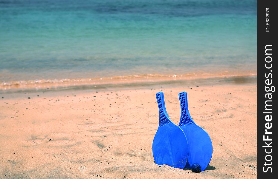 Bat and ball on the sandy beach. Bat and ball on the sandy beach