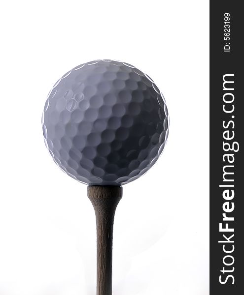Golf ball on a tee with white background