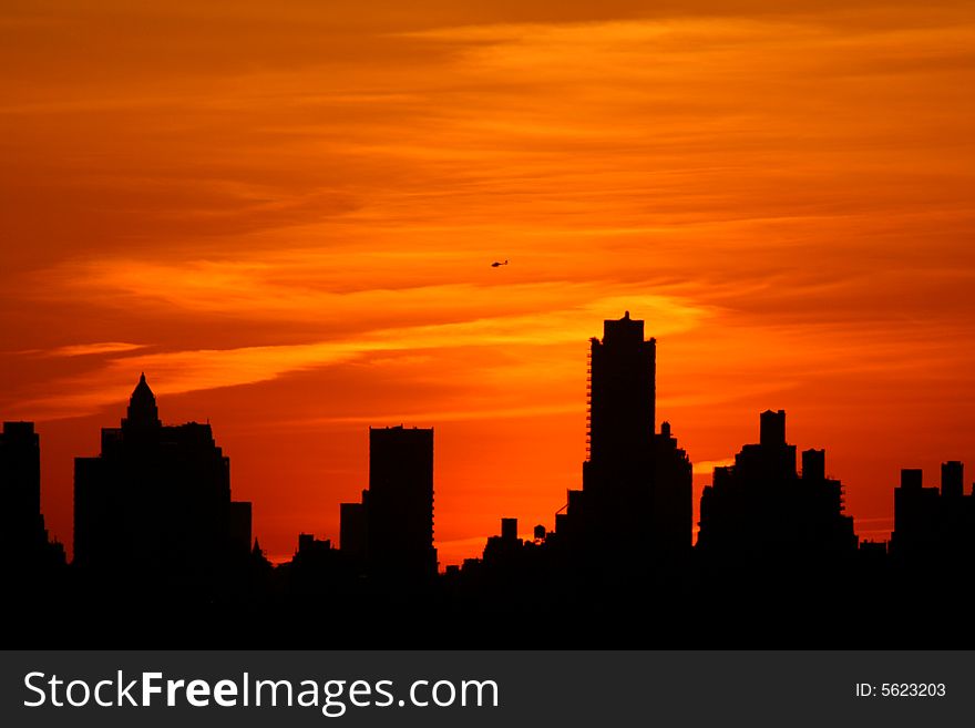 Silhouette of Manhattan highrises at sunset. Silhouette of Manhattan highrises at sunset.