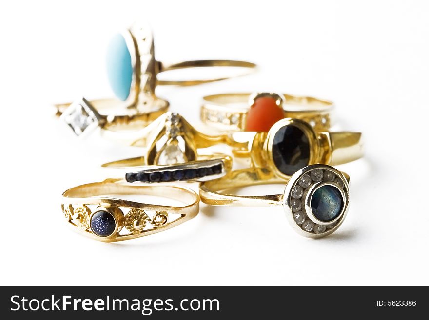 Many golden rings with precious stones