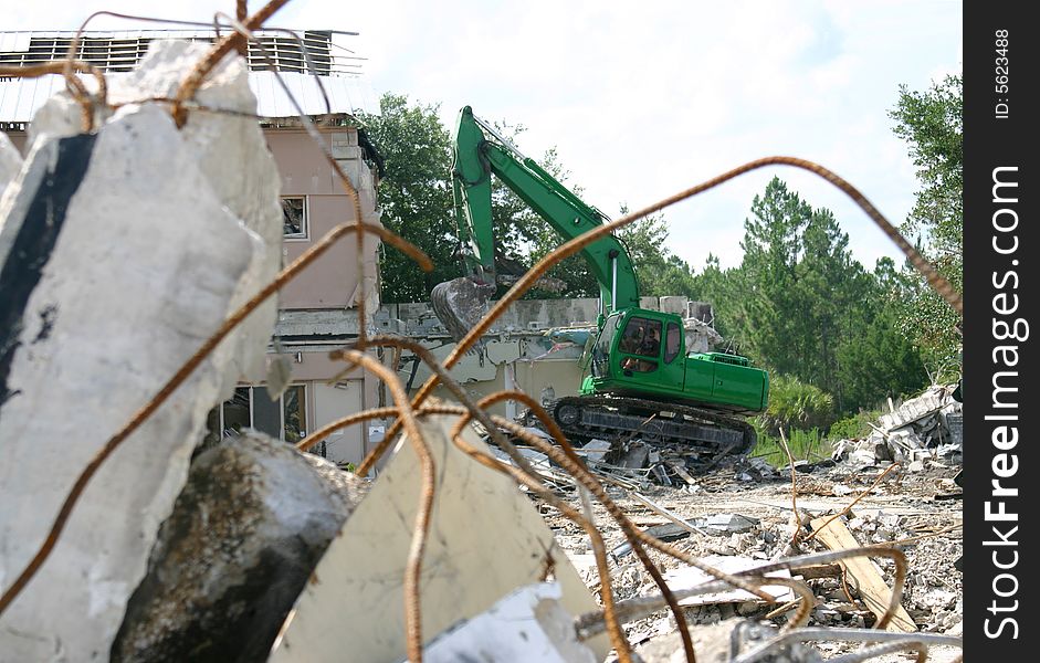 Medium weight shovel tearing down a building in preparation for construction. Medium weight shovel tearing down a building in preparation for construction.