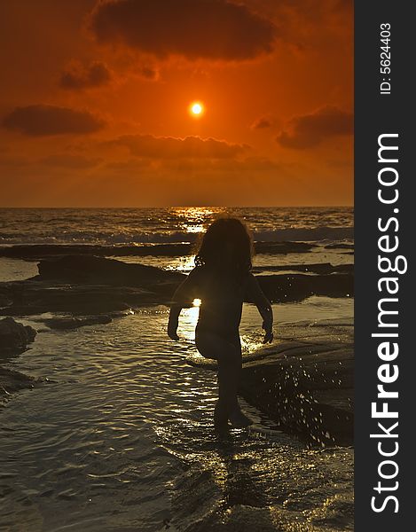 Little girl at the beach in sunset. Little girl at the beach in sunset