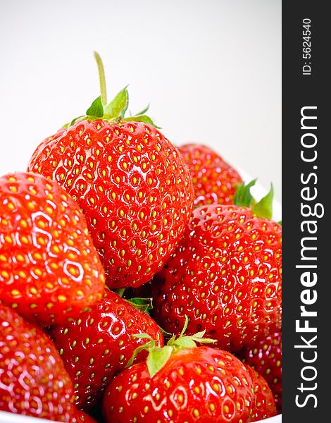 Some delicious strawberries in a white bowl whit white background