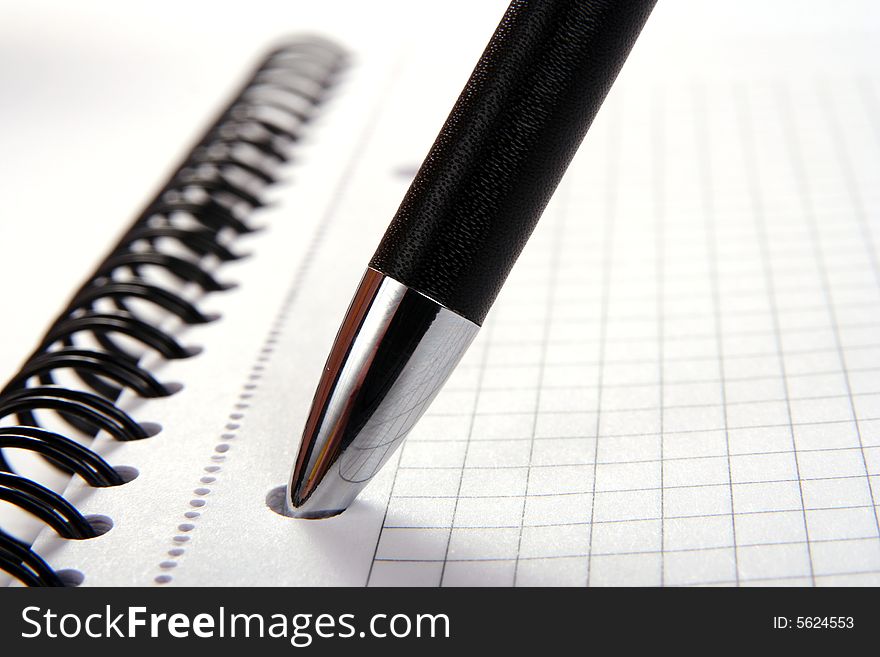 Notebook with pen isolated on white background