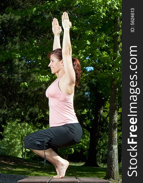 Woman Doing Yoga In The Park - Vertical
