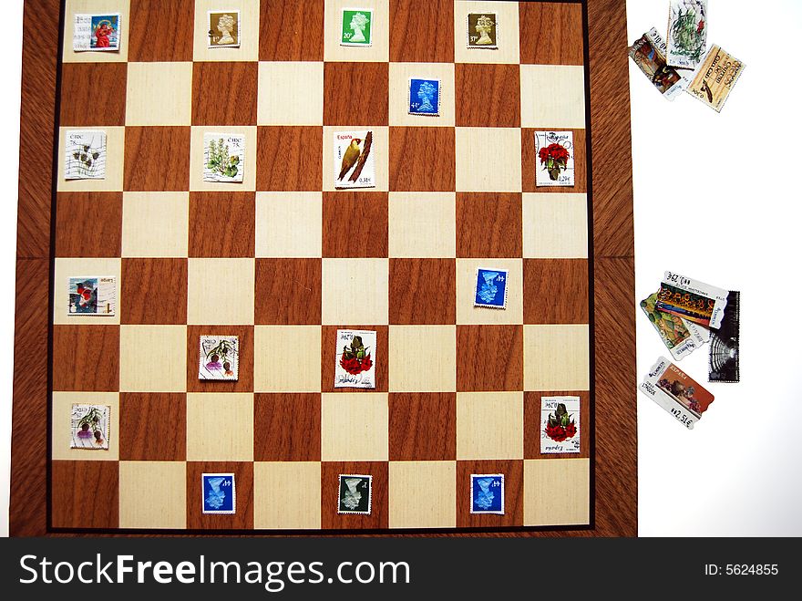 Some postage stamps over a chess set