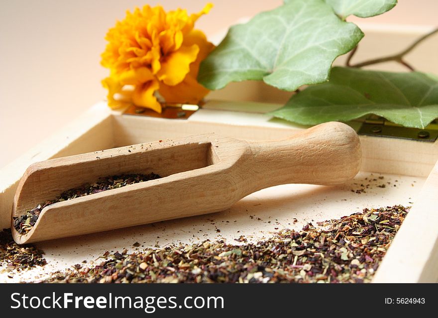 Herbs being prepared on a wooden table. Herbs being prepared on a wooden table.