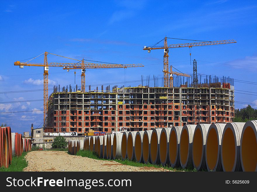 Concrete pipes for construction of new sewer system. Construction of a complex of buildings