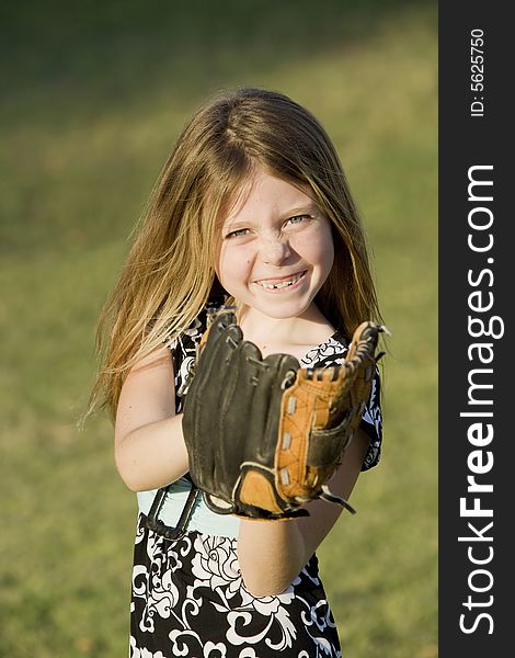 Cute Young Girl With A Baseball