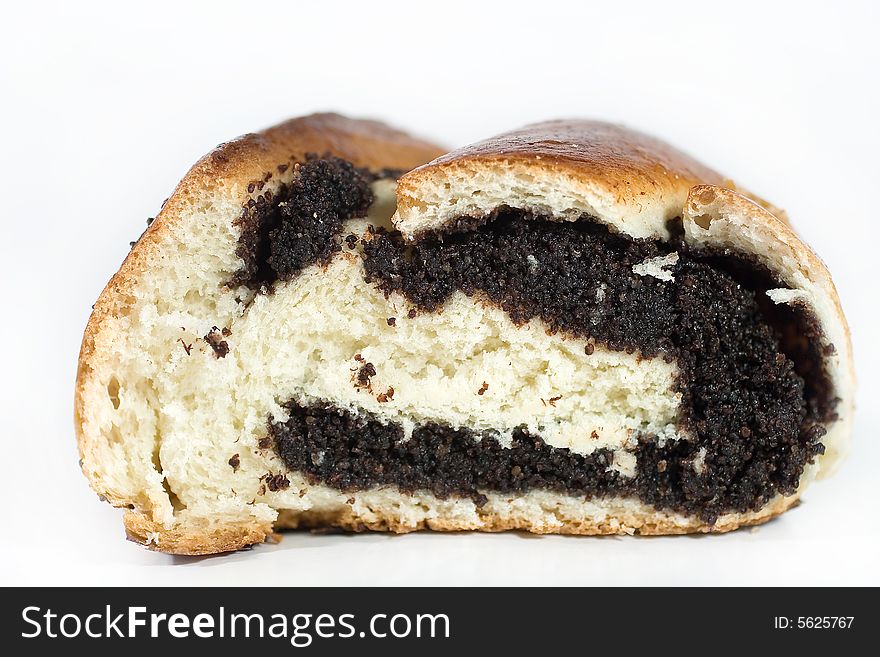 Closeup of a sliced roll with poppy seeds (on white)