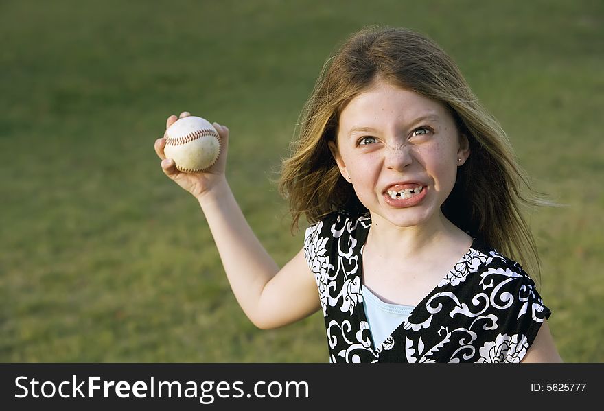 Cute Young Girl With A Baseball