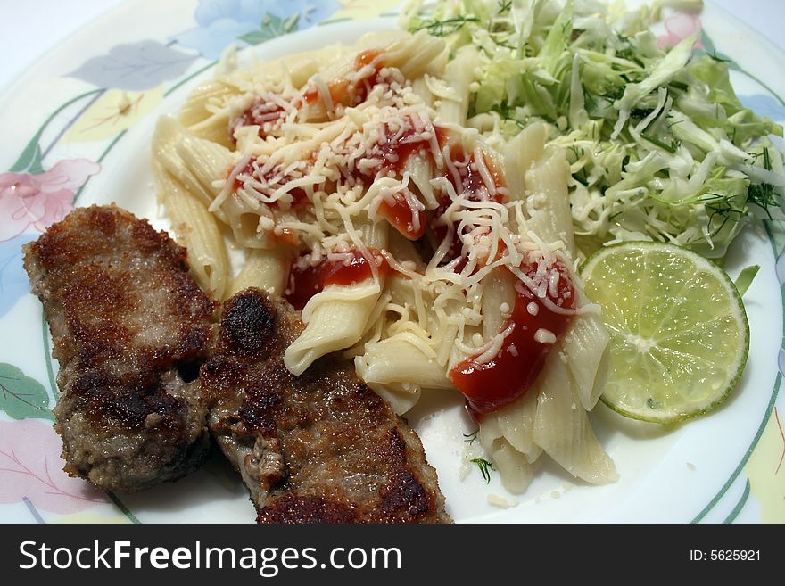 Pork chops with the pasta strewed by parmesan, and cabbage salad