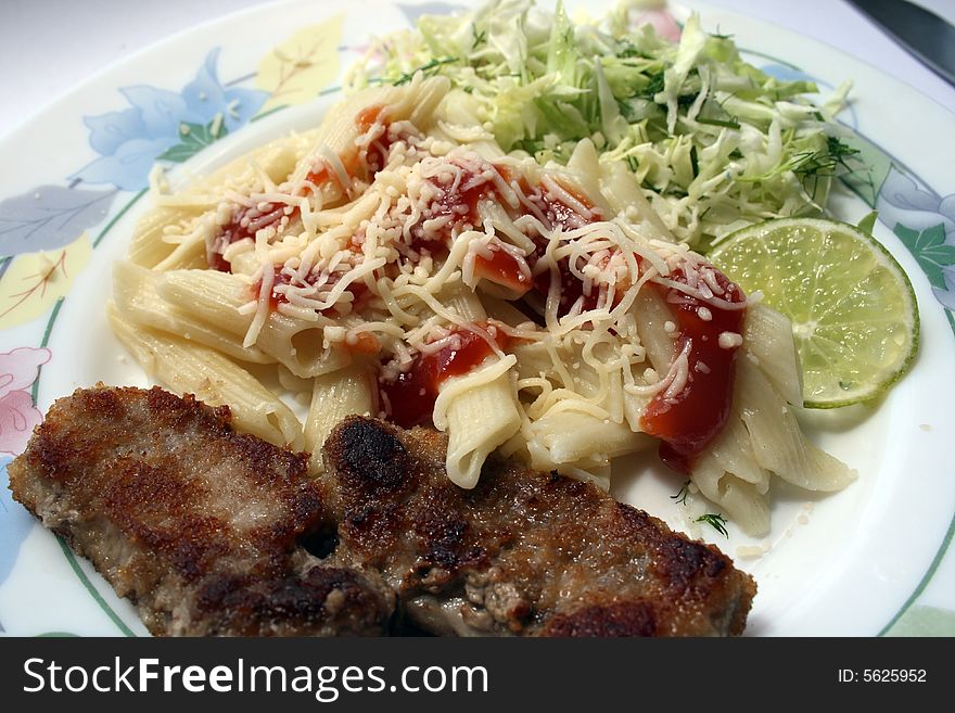 Pork chops with the pasta strewed by parmesan, and cabbage salad