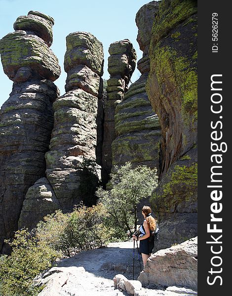 A Hiker Dwarfed By  Standing Up Rocks