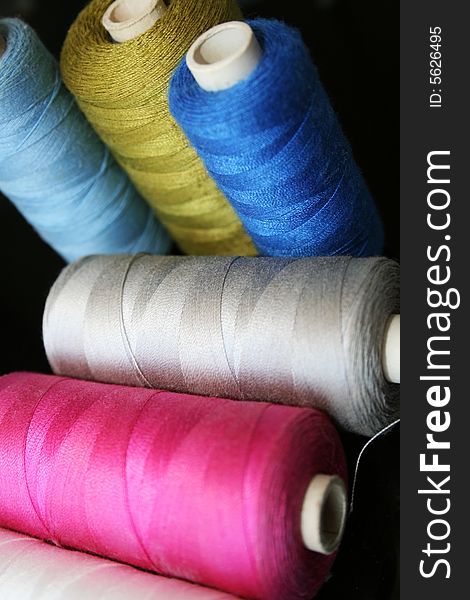 Cotton in different colors on black background. Cotton in different colors on black background.