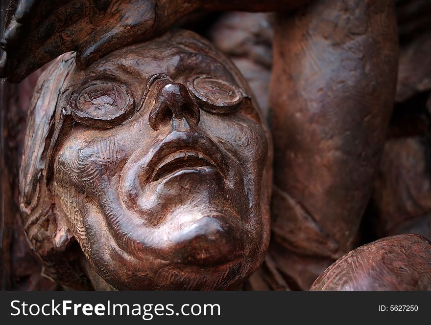 Detail of a sculpture featuring an old woman looking at the sky with fear. Detail of a sculpture featuring an old woman looking at the sky with fear