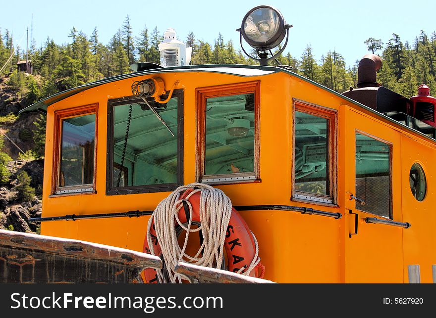 Small wheel house on a yellow tugboat. Small wheel house on a yellow tugboat