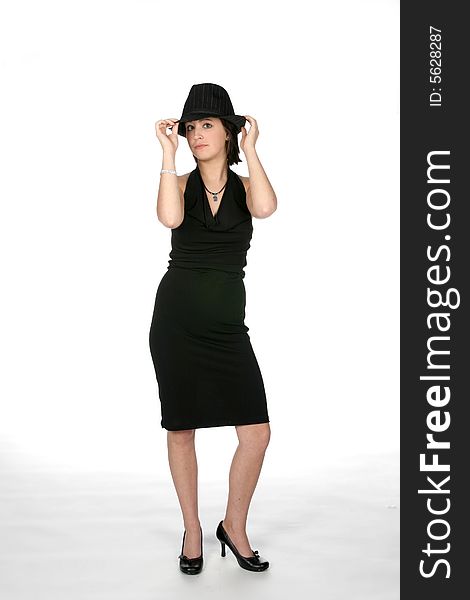 Slim teen in black dress wearing a top hat and looking cute