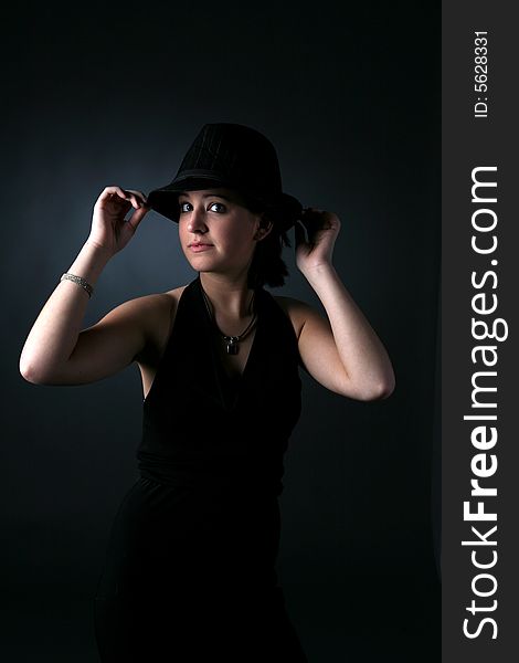 Teenage girl in top hat with dramatic lighting. Teenage girl in top hat with dramatic lighting