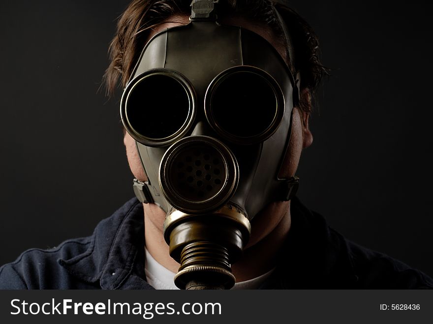 Man in gasmask with dark background