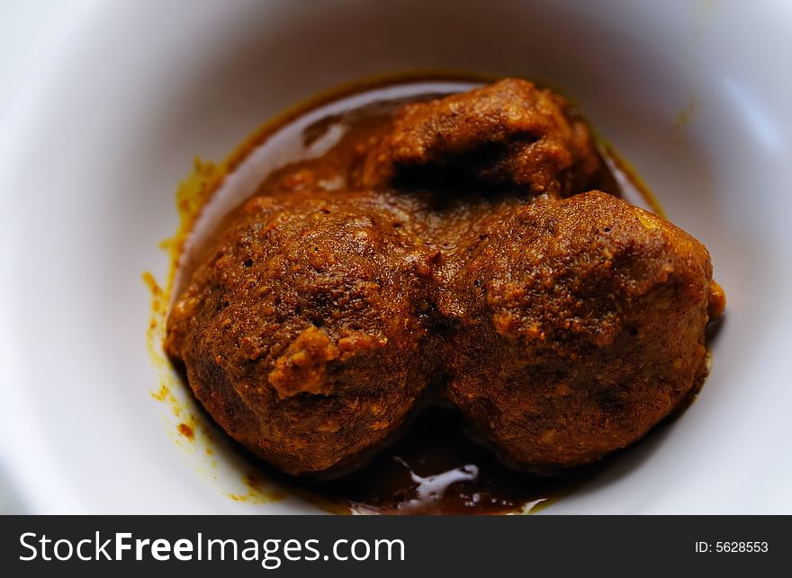 Close shot of a pair of curry meat balls. Close shot of a pair of curry meat balls.