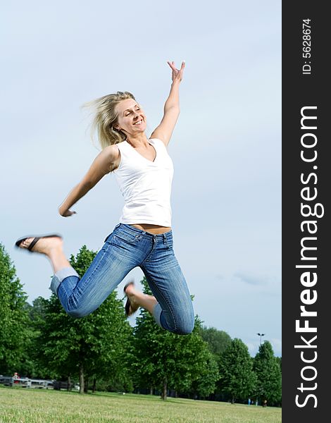 Happy jumping woman in the park. Happy jumping woman in the park.