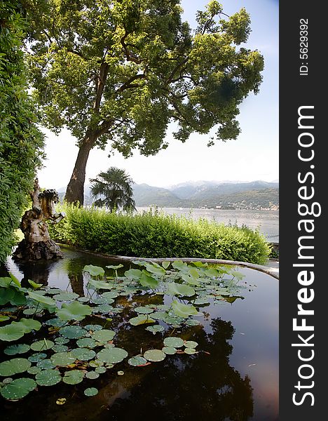 Italian scenic: the pond of a old villa in classical style, Lago Maggiore, Italy. Italian scenic: the pond of a old villa in classical style, Lago Maggiore, Italy.