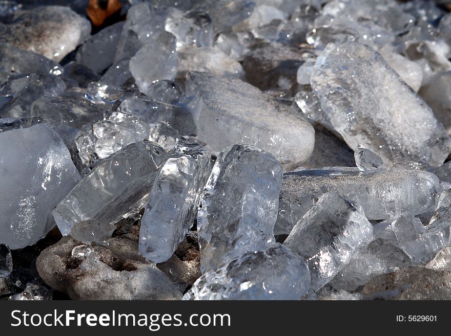 A detailed image of chunks of ice accented by sunlight on pebbled. A detailed image of chunks of ice accented by sunlight on pebbled