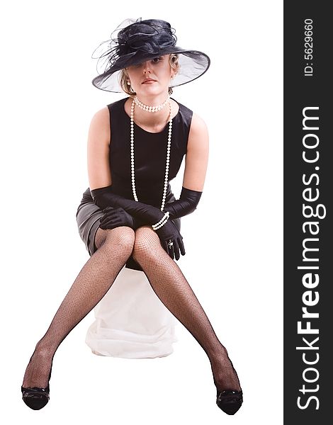 Women in black with hat sitting on pedestal. Women in black with hat sitting on pedestal