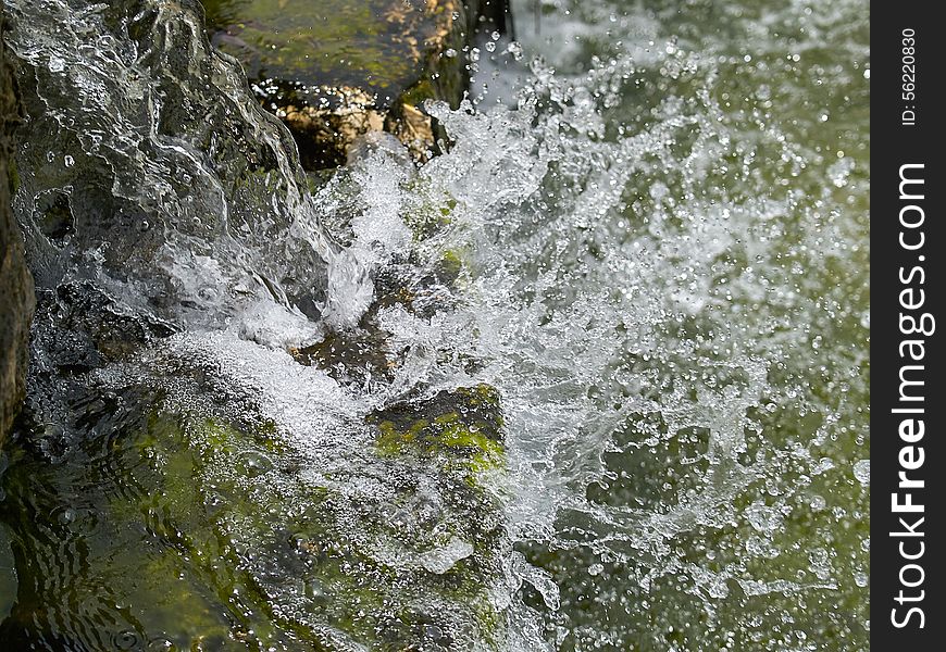 Closeup of water splash drops freezed in motion