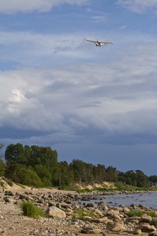 Plane In The Sky Above The Sea Coast Royalty Free Stock Photography Plane In The Sky Above The Sea Coast Royalty Free Stock Photography