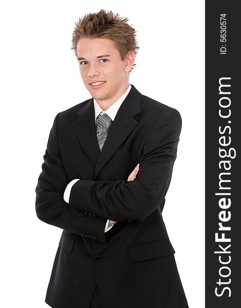 A young businessman standing looking casual. A young businessman standing looking casual