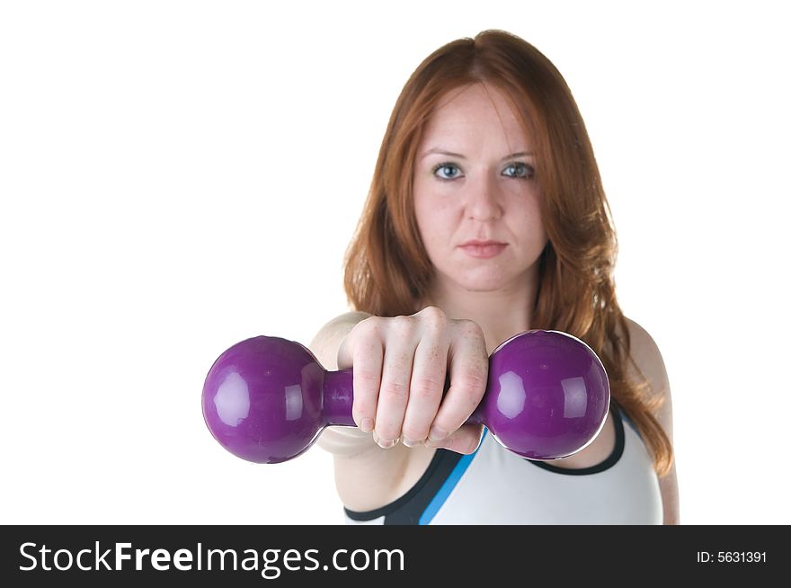 Pretty young red haired woman with focus on hand and weights. Pretty young red haired woman with focus on hand and weights