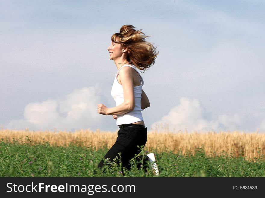 A beautiful girl running on the field