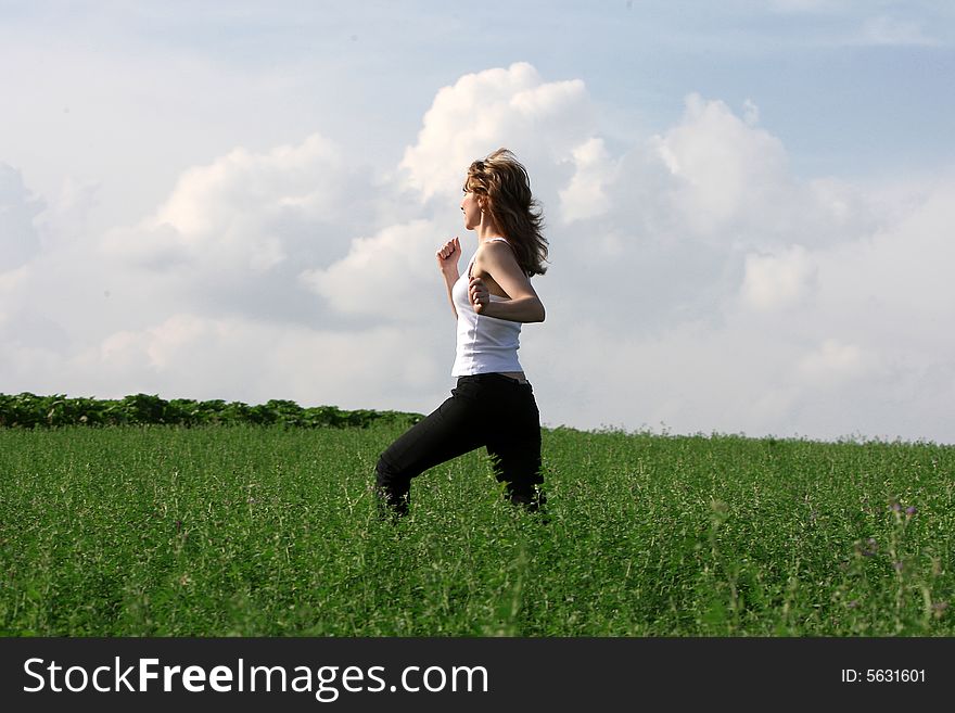 A beautiful girl running on the field