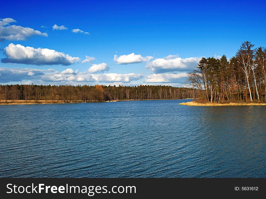 A blue lake and blue skies