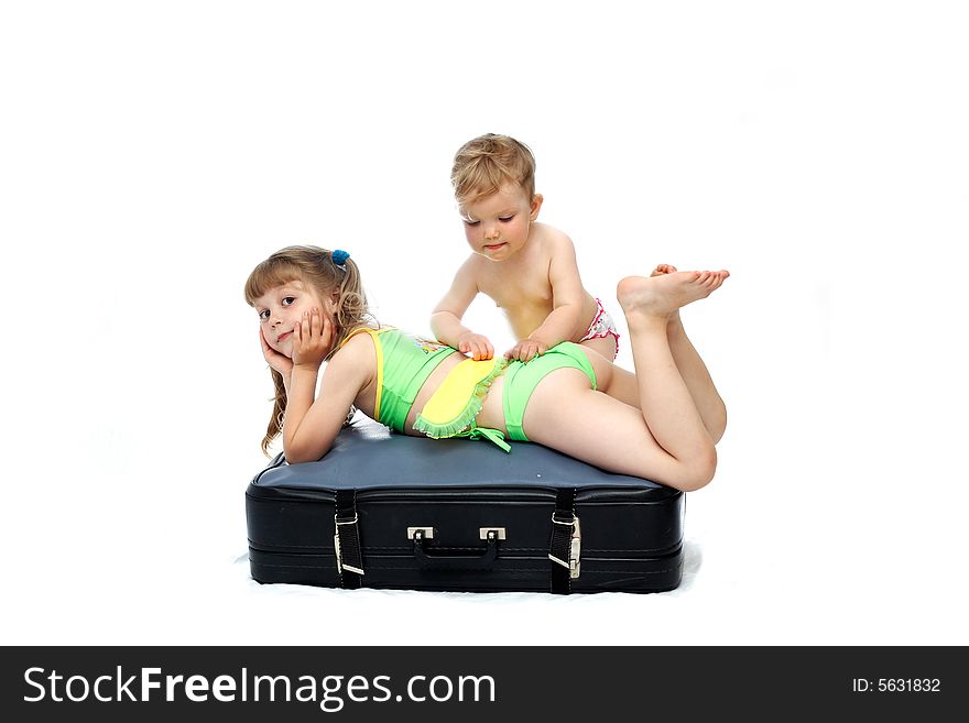 Two girls playing on a black valise. Two girls playing on a black valise