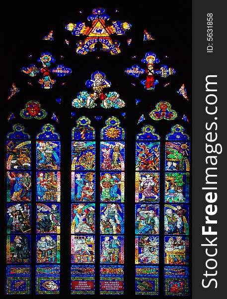 A old stained-glass window is in a church. A old stained-glass window is in a church