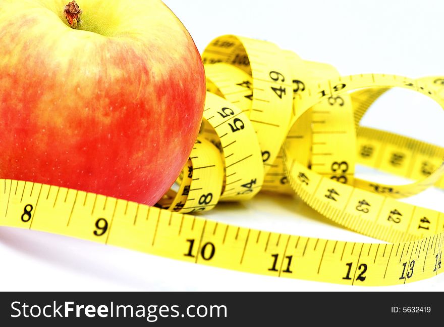 A shot of an apple with tape measure. A shot of an apple with tape measure