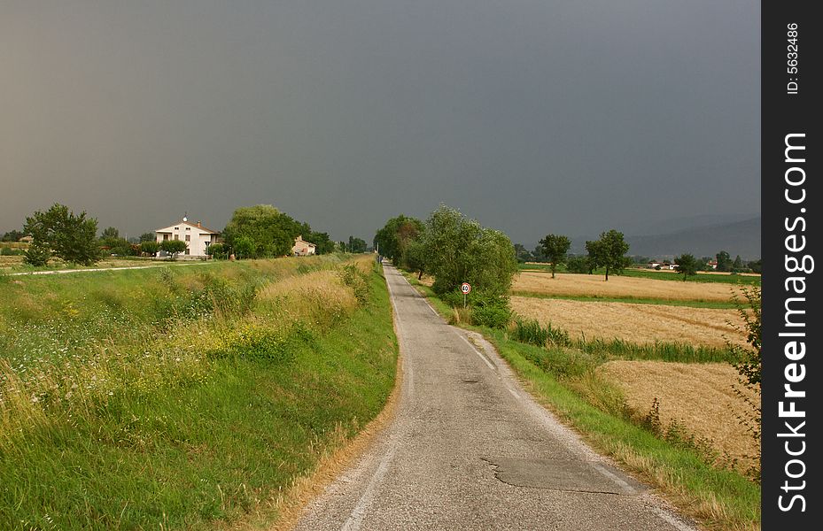 Umbria landscape with road and storm clouds. Umbria landscape with road and storm clouds