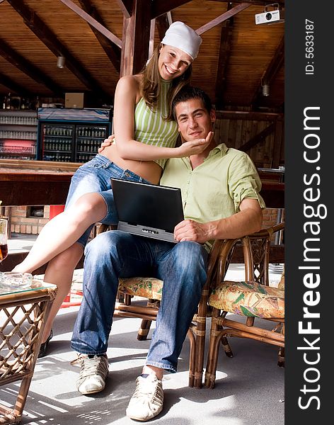 Young man and woman in restaurant with laptop. Young man and woman in restaurant with laptop