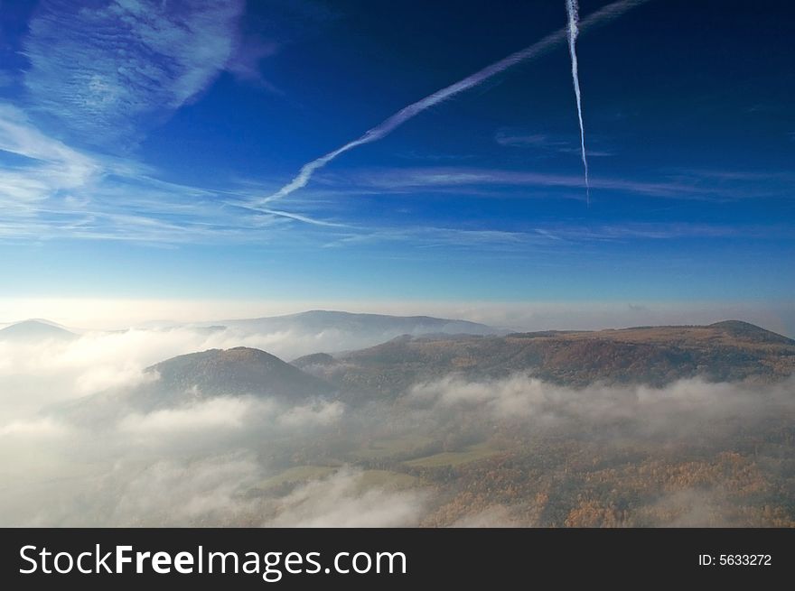 Blue summer sky and misty mountains. Blue summer sky and misty mountains