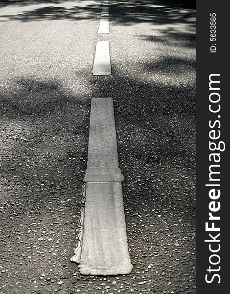 The strip of a marking of asphalt road and shadow from roadside trees create the freakish figure considered by the missing passer-by. The strip of a marking of asphalt road and shadow from roadside trees create the freakish figure considered by the missing passer-by