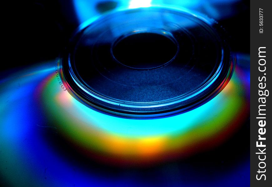 A close-up of a high technology data storage equipment - compact disc/ digital video disc with a  rainbow. A close-up of a high technology data storage equipment - compact disc/ digital video disc with a  rainbow.