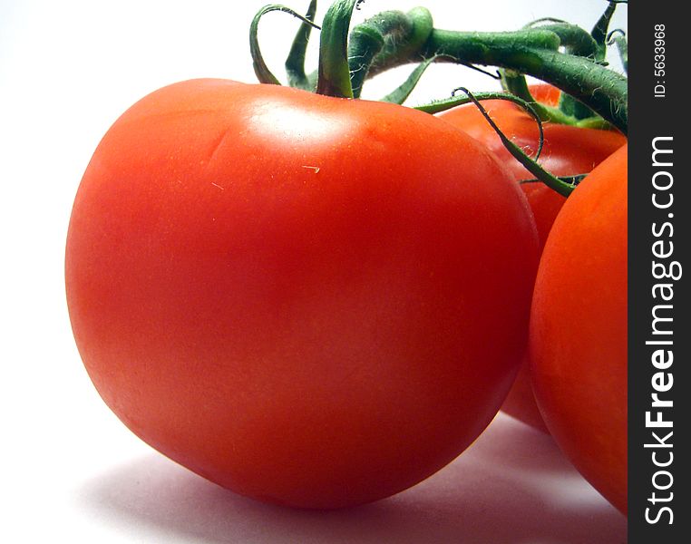 Cluster of tomatoes on a white background
